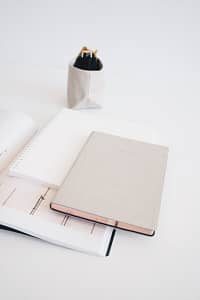 three assorted-color notebooks