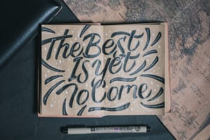 the best is yet to come-printed board beside white pen