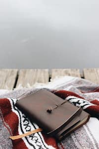 brown leather wallet on red and white textile