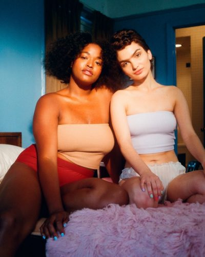 Photo by Billie two woman sitting on bed inside room