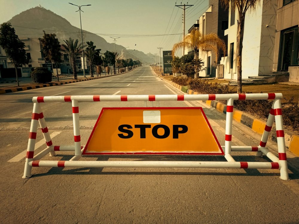 a barricade on a street with a stop sign on it