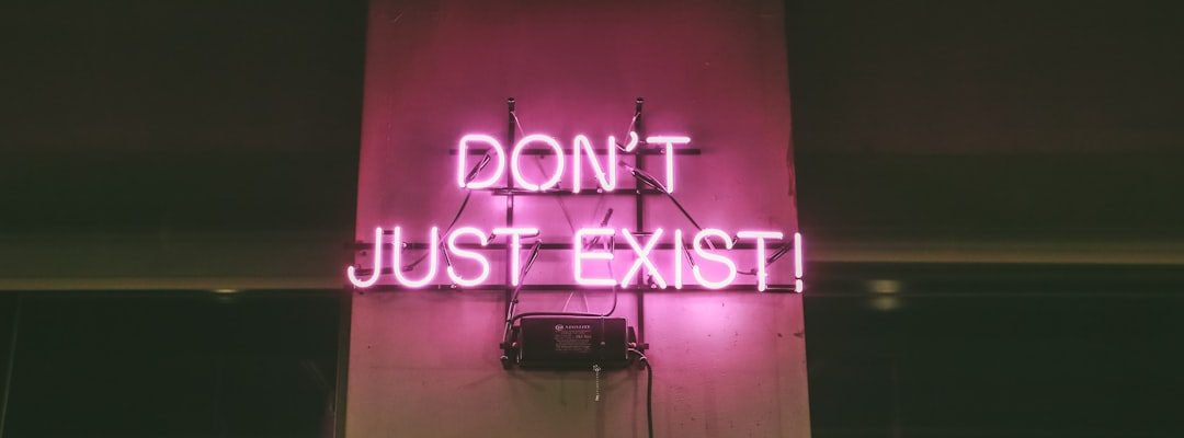 purple Don't Just Exist neon signage turned-on