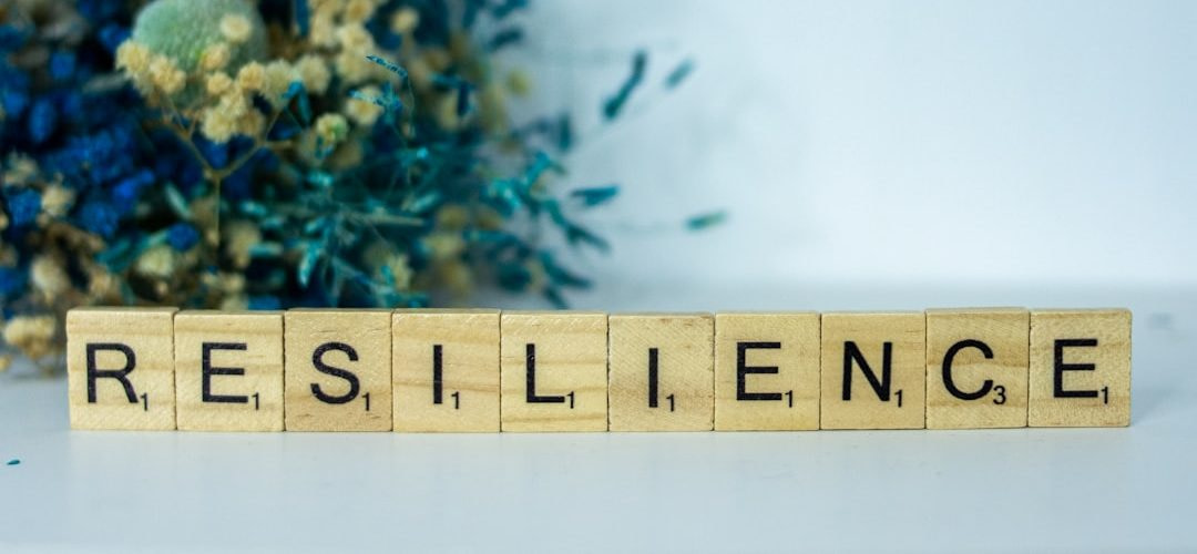 a scrabble type block spelling the word resilince
