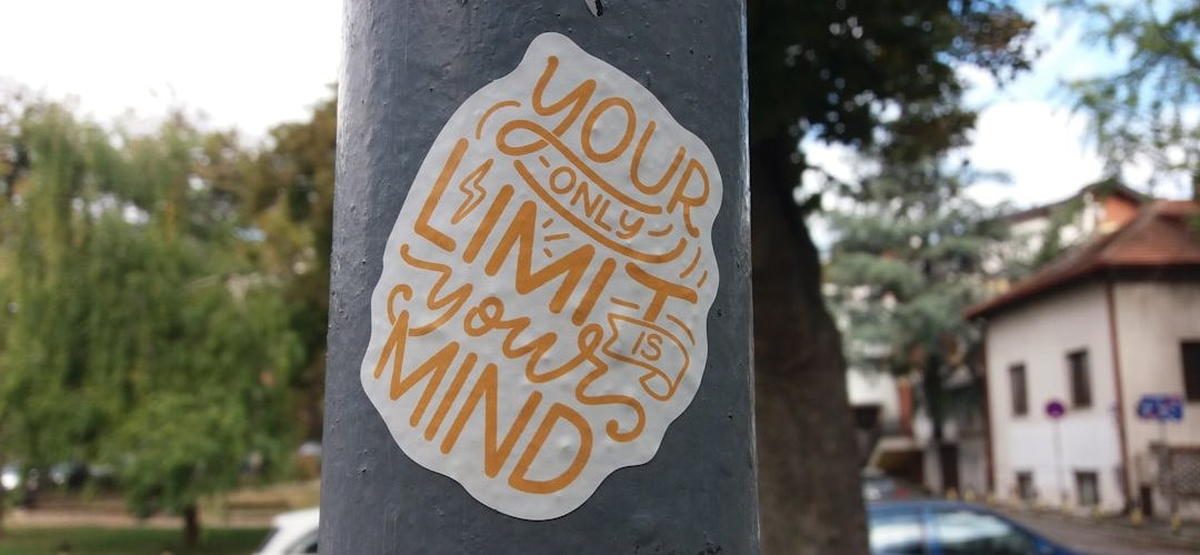 a sticker on a pole on a city street