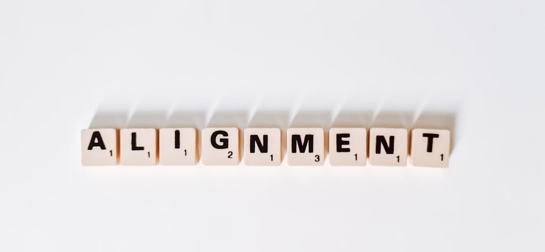 the word alignmentment spelled with scrabble letters