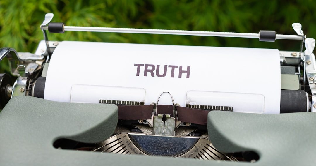 a close up of a typewriter with the word truth on it
