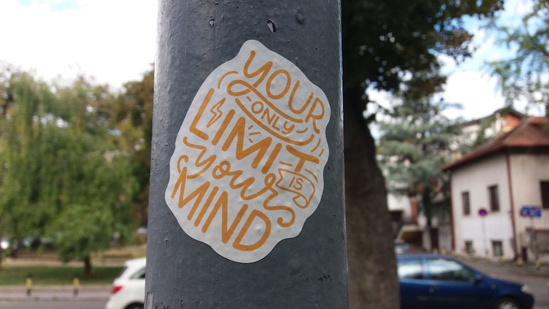 a sticker on a pole on a city street
