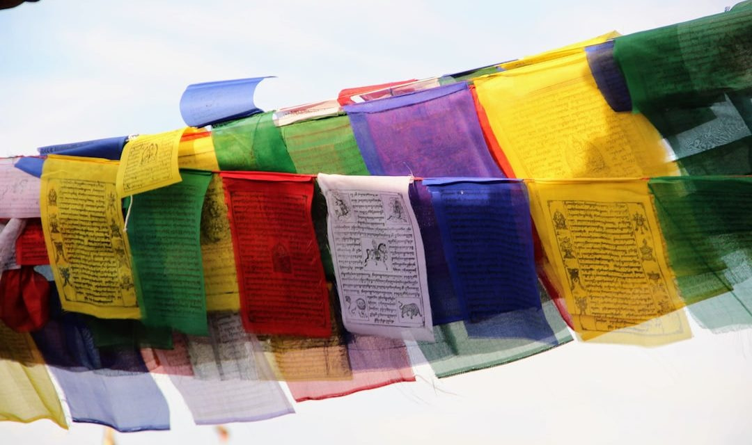 a bunch of colorful flags hanging from a line