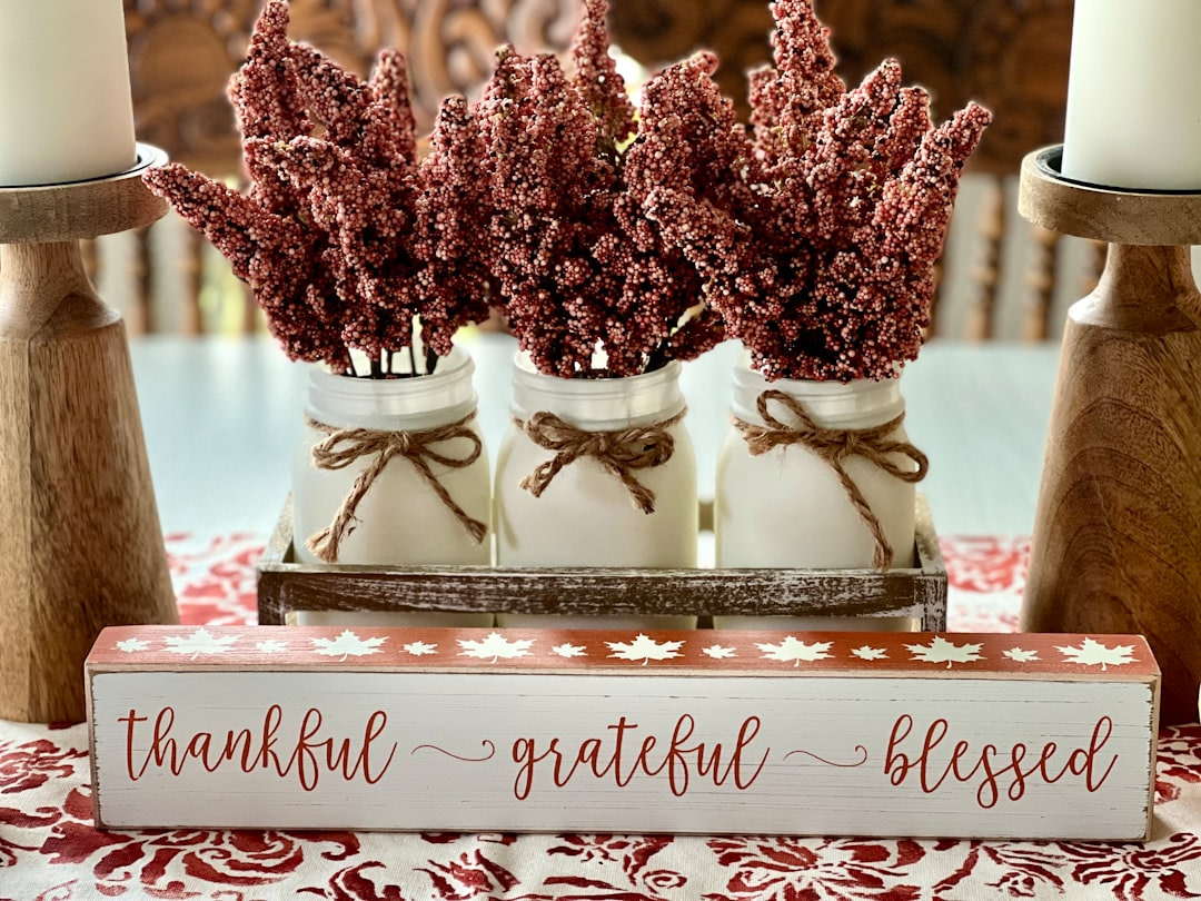 a couple of jars filled with flowers on top of a table