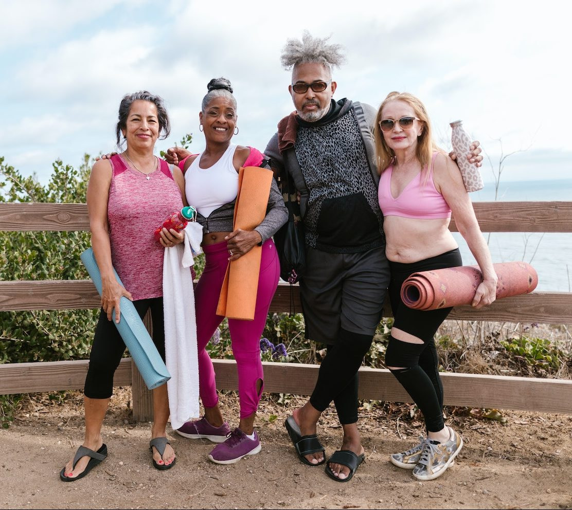 People Standing Beside A Wooden Fence