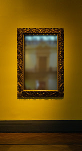 rectangular leaning mirror with brass-colored frame