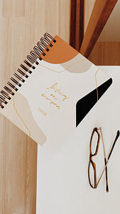 black framed eyeglasses on white paper