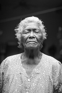 grayscale photo of closed-eyes woman
