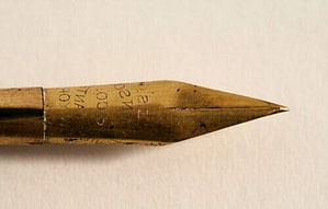 closeup photo of gold fountain pen