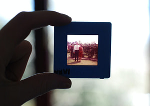 person holding square black photo frame