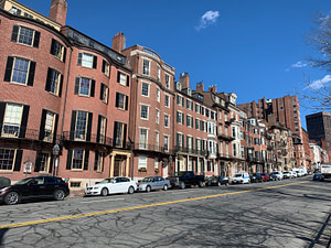 cars parked in front of brown concrete building during daytime