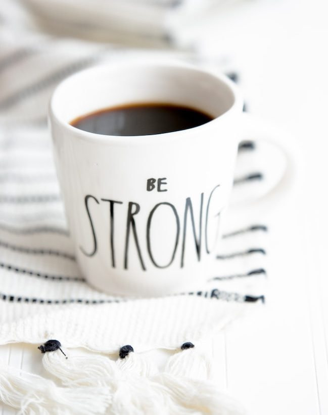 white ceramic mug filled with black coffee