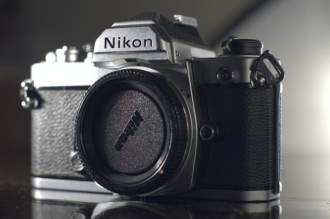 black and silver nikon dslr camera
