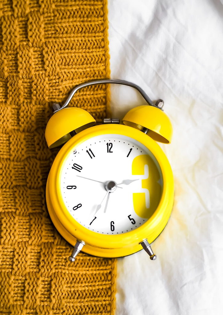 yellow and white alarm clock at 10 10