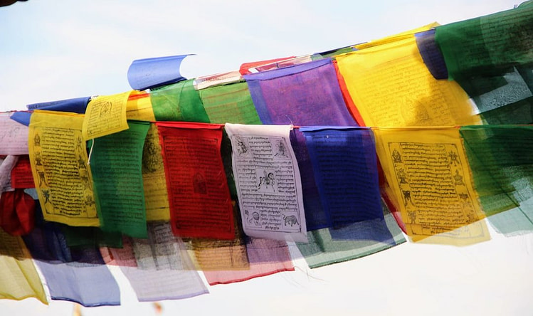 a bunch of colorful flags hanging from a line