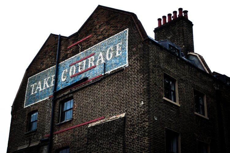 brown brick building with blue and white signage