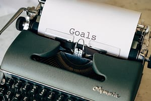 black and white typewriter on green textile