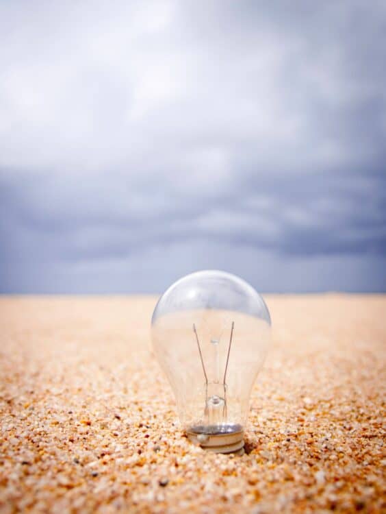 clear glass light bulb on sand during daytime