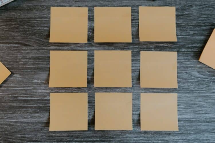 yellow sticky notes on brown wooden table